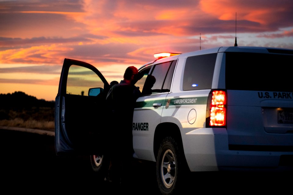 Park ranger and vehicle at sunset