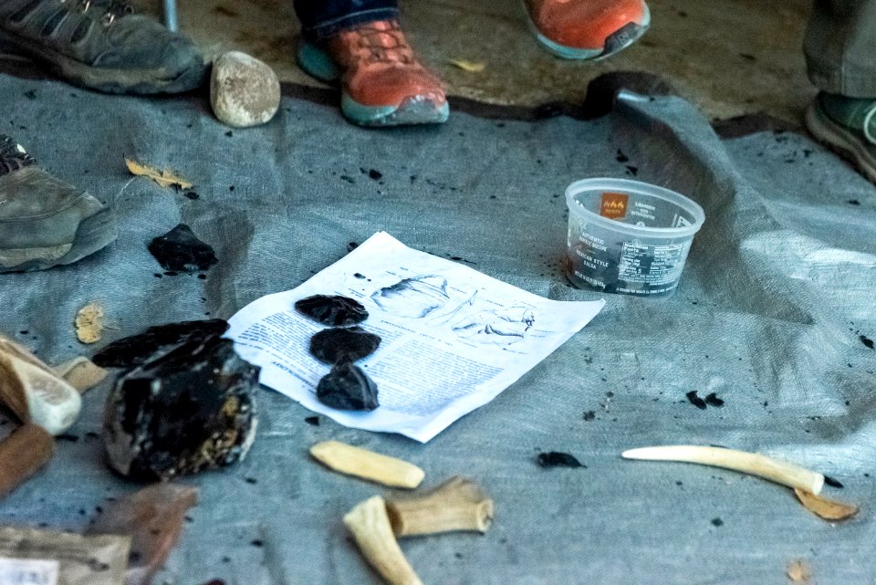 Park staff learning flintknapping techniques