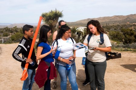 2017 Student Summit on Climate Change - Joshua tree Monitoring Project - Students check the location of study Joshua trees on a map photo