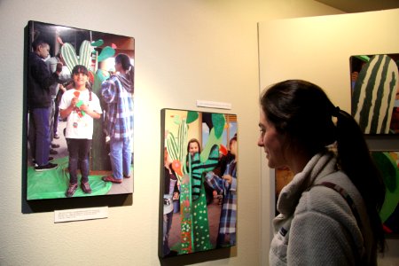 Looking at Photos Documenting the Creation of the Crazy Cactus Student Art Exhibit