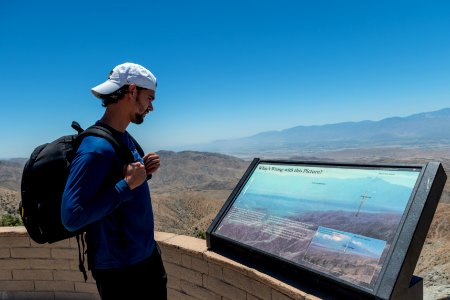 Visitor reading a wayside photo