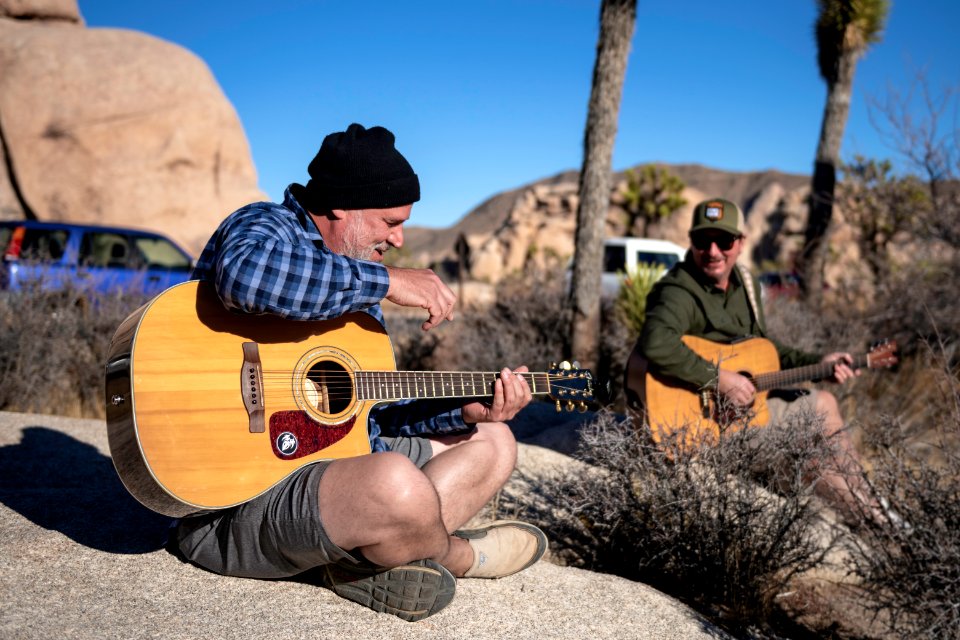 Two guitar players in front of Intersection Rock