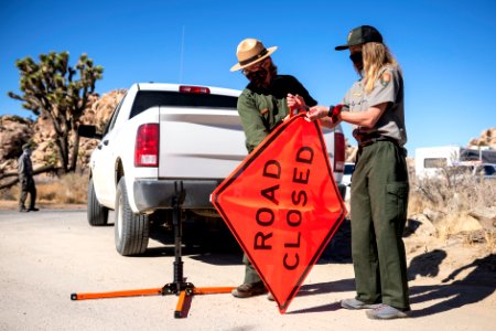 Peak Operations putting up a Road Closed sign