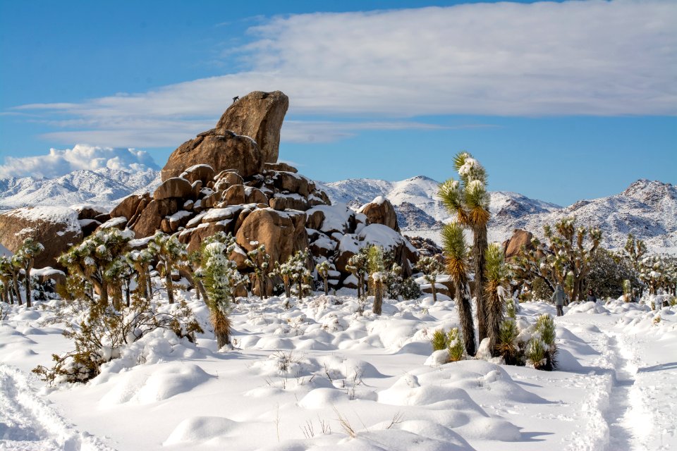 Climber on Headstone Rock surrounded by snow
