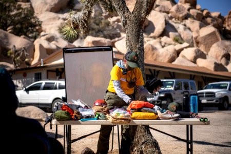 Joshua Tree Search and Rescue team members discussing pack items