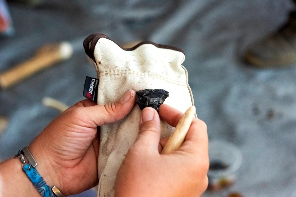 Park staff learning flintknapping techniques