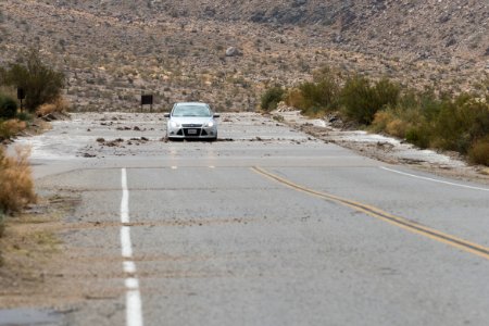 A visitor drives through water on the road; 8/26/15