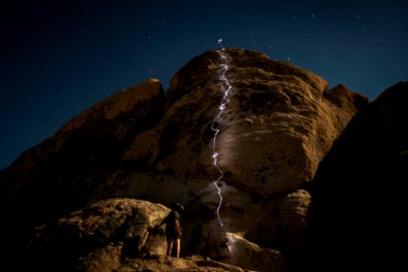Night climbing headlamp trails photo