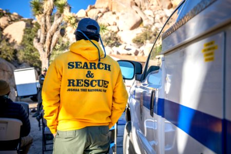 Joshua Tree Search and Rescue team member next to vehicle