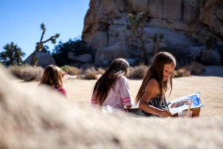 Three girls painting on field trip