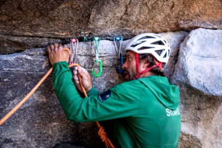 Climber steward placing gear at Gunsmoke photo