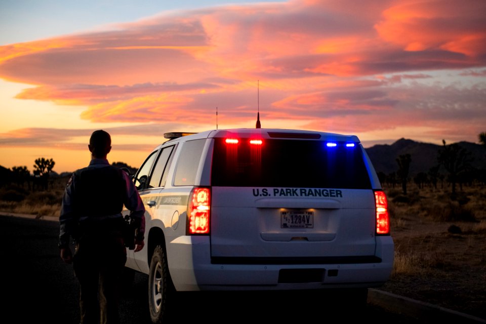 Park ranger and vehicle at sunset