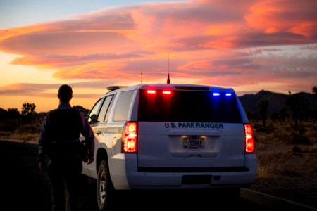 Park ranger and vehicle at sunset