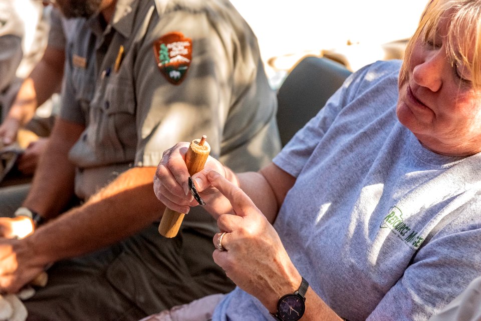 Park staff learning flintknapping techniques