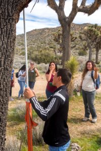2017 Student Summit on Climate Change - Joshua tree Monitoring Project - Students measure the height of a Joshua tree photo