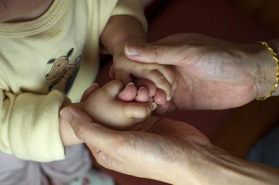 Mother and son baby hand