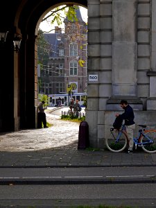 Free photo from Amsterdam city - a phone-break at the old city gate, free picture by Fons Heijnsbroek, october 2018