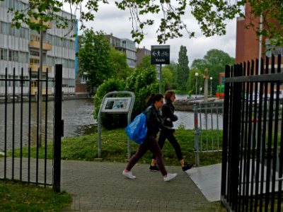Two students in the morning to college on the campus Roeterseiland, university area; urban photography of Amsterdam, Fons Heijnsbroek