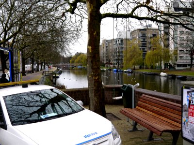 View over the Mauritskade - looking in the direction of Amsterdam center, river Amstel - with plane trees along the canal border - in the light of gray December, Amsterdam city; - urban photography by Fons Heijnsbroek, the Netherlands, 2013 photo