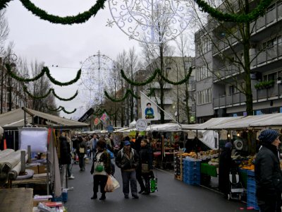 Photo of the Dappermarkt (daily marketplace) in district Amsterdam Oost (East) and shopping people - on a gray day in December with Christmas lights in the streets; Amsterdam city; - urban photography by Fons Heijnsbroek, the Netherlands, 2013 photo