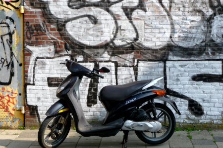 2011.04 - 'Urban street & graffiti art', some large throw-ups on an old brick-stone wall, along the canal Prinsengracht with sunlight and shadows and a scooter, photo Amsterdam city; urban photographer Fons Heijnsbroek  - geotag, The Netherlands