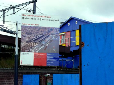 2006.10 - 'Billboard: re-building the Central Station area' - Amsterdam photos & pictures, location along the train track together with construction chains; east-side of the stationr; Dutch city + geotag, Fons Heijnsbroek, The Netherlands photo