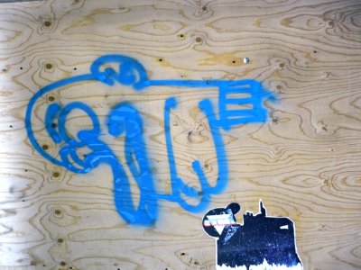 Urban street-art graffiti on a wooden construction-wall on Plantage Muidergracht: a painted blue sign and a pasted black-white image; photo Amsterdam city; urban photographer Fons Heijnsbroek, 2013 photo