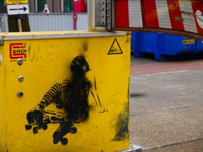 2016.04 - Amsterdam photo of urban street-art; stencil-art on a temporarily road barrier for regulating the tram traffic on the track; geotagged free urban picture, in public domain / Commons; Dutch photography, Fons Heijnsbroek, The Netherlands