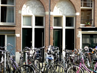 Photo, facade and front decorations of residential blocks in Balthasar Floriszstraat, Amsterdam Oud-Zuid; with parked bicycles in front of the frontal - in the sunlight of the summer; - urban photography by Fons Heijnsbroek, the Netherlands, 2014 photo