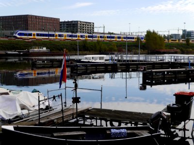 Free photo of Amsterdam city - a picture of the wide canal-water of the Dijksgracht along the train track around the city, by Fons Heijnsbroek, october 2018. photo