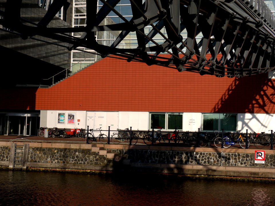 View from the ground level  on the facade and entrance bridge of Muziekgebouw aan 't IJ, located on the border of river Ij in Amsterdam city; - urban photography by Fons Heijnsbroek, the Netherlands