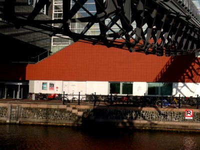 View from the ground level on the facade and entrance bridge of Muziekgebouw aan 't IJ, located on the border of river Ij in Amsterdam city; - urban photography by Fons Heijnsbroek, the Netherlands photo