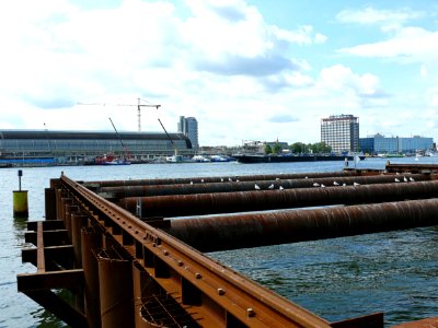 2007.08 - 'Wide city-scape over pilings in the river IJ' and the caps of Central Station and rusty sheet pilings in front of the view in direction of Amsterdam; the North side; Dutch city photo + geotag, Fons Heijnsbroek, The Netherlands