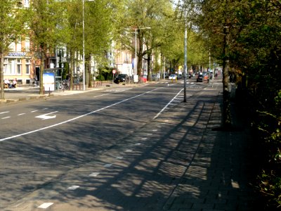 2013.04 - 'A street-view in the street Kattenburgergracht with a characteristic urban row of elm trees in blossom of Spring, on the border of the old city center of Amsterdam; urban photography, Fons Heijnsbroek photo