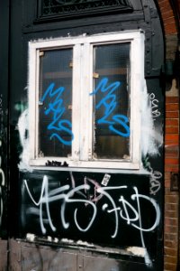 2011.04 - 'Decorated front-door covered with graffiti tags', of a 19th century residence; Amsterdam city in Spring; geotag free urban picture, in public domain / Commons CCO;  city photography by Fons Heijnsbroek, The Netherlands