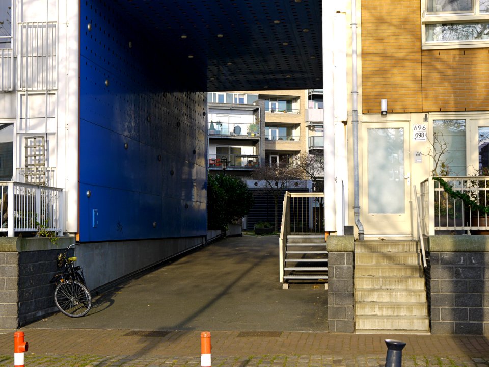 Facade & large gate of residential houses on Javakade with varying modern architecture style and colors in one building site; location: borders of river IJ in the old harbours of Amsterdam; - urban photography by Fons Heijnsbroek, the Netherlands