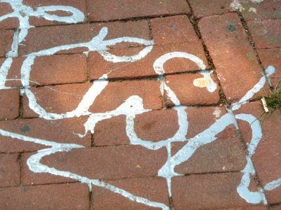 2011.05 - 'Close-up view on a reflecting silver-written graffiti tag on the brick pavement near the bridge over Nieuwe Herengracht; geotag free urban picture, in public domain / Commons CCO; city photography, Fons Heijnsbroek, Amsterdam, The Netherlands photo