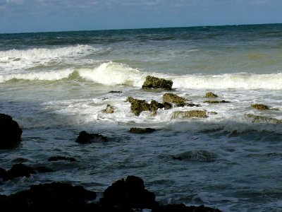 2007.09 - 'Still life seascape of light and shadows', a splashing surf on rocks on the shores of Petit-Dalle in Normandy France with a quiet sea; French landscape photography, Fons Heijnsbroek photo