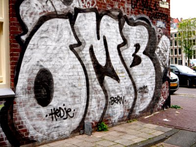 Urban street-art graffiti; a large throw-up in silver-white colors, on the edge of the canal Oude Schans in Amsterdam city, on a brick house-wall, in November 2013; photo Amsterdam city; urban photographer Fons Heijnsbroek, 2013 photo