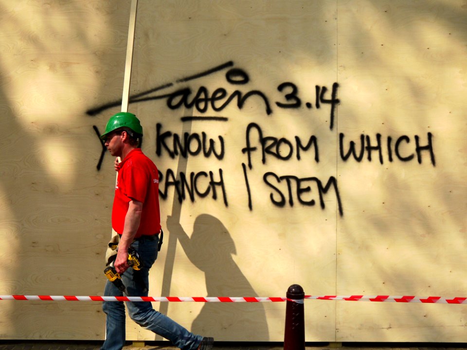 2015.04 - Amsterdam photo of street-art and a workman, A wall-writing & shadows on the wooden construction-fence in the street Keizersgracht; a geotagged free urban picture, in public domain / Commons CCO; city photography, Fons Heijnsbroek, Netherlands photo