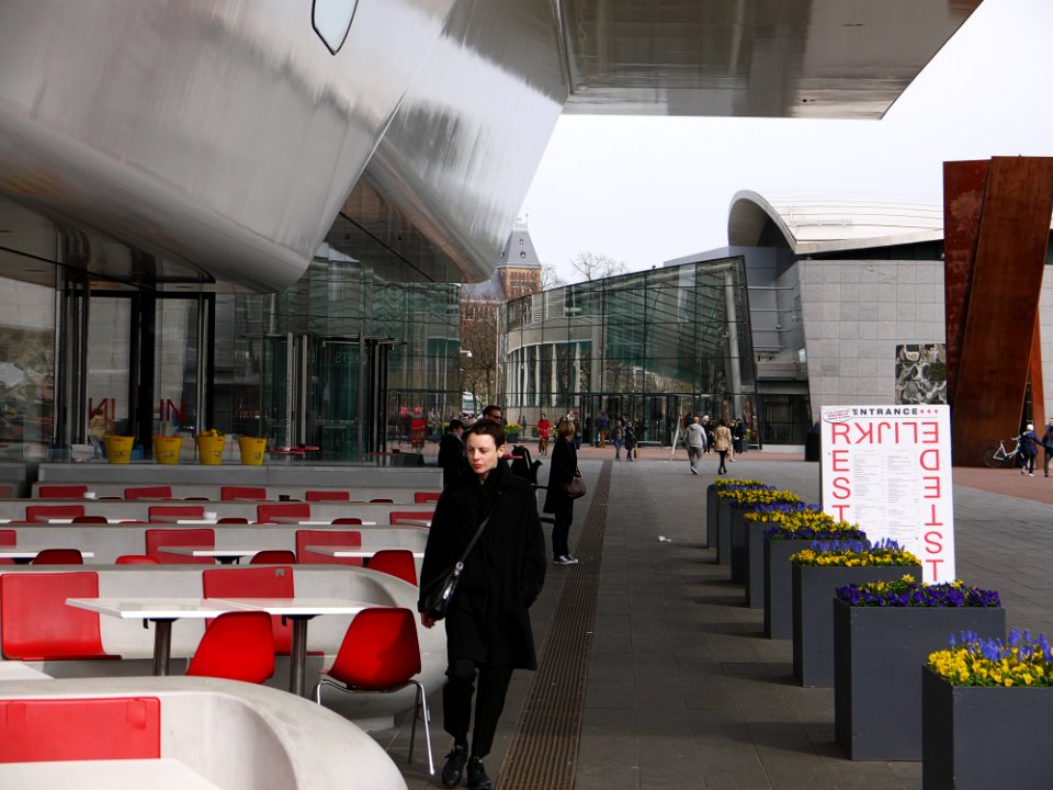 2016.04 - Amsterdam photo pf people in the city, walking under the public outdoor roof of Stedelijk Museum at the square Museumplein - geotagged free urban picture, in public domain / Commons; Dutch photography, Fons Heijnsbroek, The Netherlands