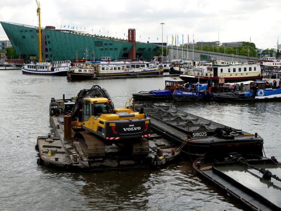2013.06 - 'View on the NEMO museum', on the horizon to the left and municipal dredge boats in the fore-ground of the Oosterdok; urban photography Amsterdam by Fons Heijnsbroek, Amsterdam