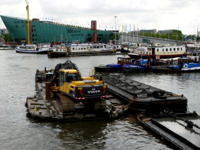 2013.06 - 'View on the NEMO museum', on the horizon to the left and municipal dredge boats in the fore-ground of the Oosterdok; urban photography Amsterdam by Fons Heijnsbroek, Amsterdam photo