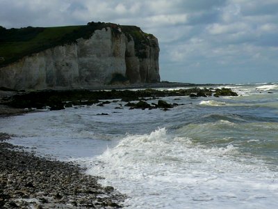 2007.09 - 'Low view with sun and shadows on cliffs and sea under cloudy light sky; shore near Petit-Dalle in Normandy France with a quiet sea; French landscape photography, Fons Heijnsbroek photo