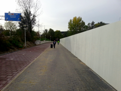 2016.10 - 'Walking over the pavement' - Amsterdam photos; view along a construction fence, close to the RAI exposition-halls in gray Autumn - geotagged free urban picture, in public domain / Commons CCO;  city photography by Fons Heijnsbroek, Netherlands