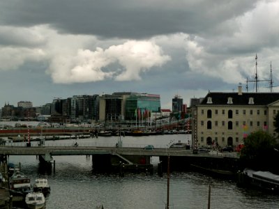 2012.07 - 'View on a gray summer-day over the Oosterdok water - in the direction of Central Station - with its old harbors and the Maritime Museum at the right - city center of Amsterdam; - urban photography by Fons Heijnsbroek, the Netherlands photo