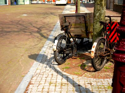 2015.05 - Amsterdam photo of a street-view - A cargo bike in the sun-light in Spring, with shadows of trees on the brick pavement; a geotagged free urban picture, in public domain / Commons CCO;  city photography by Fons Heijnsbroek, The Netherlands
