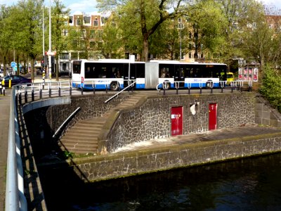 2013.04 - 'A street-view at the corner of the bridge to the Kattenburgergracht', over the canal Nieuwe Vaart; on the background urban elm trees, in Amsterdam old city - urban photography in the Netherlands, Fons Heijnsbroek
