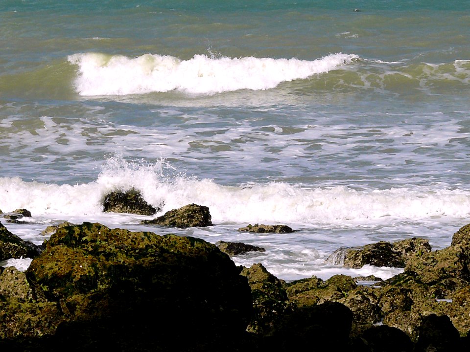2007.09 -  'Sunny still life seascape of splashing surf'. and granular rocks on the shore near Petit-Dalle in Normandy France; French landscape photography, Fons Heijnsbroek