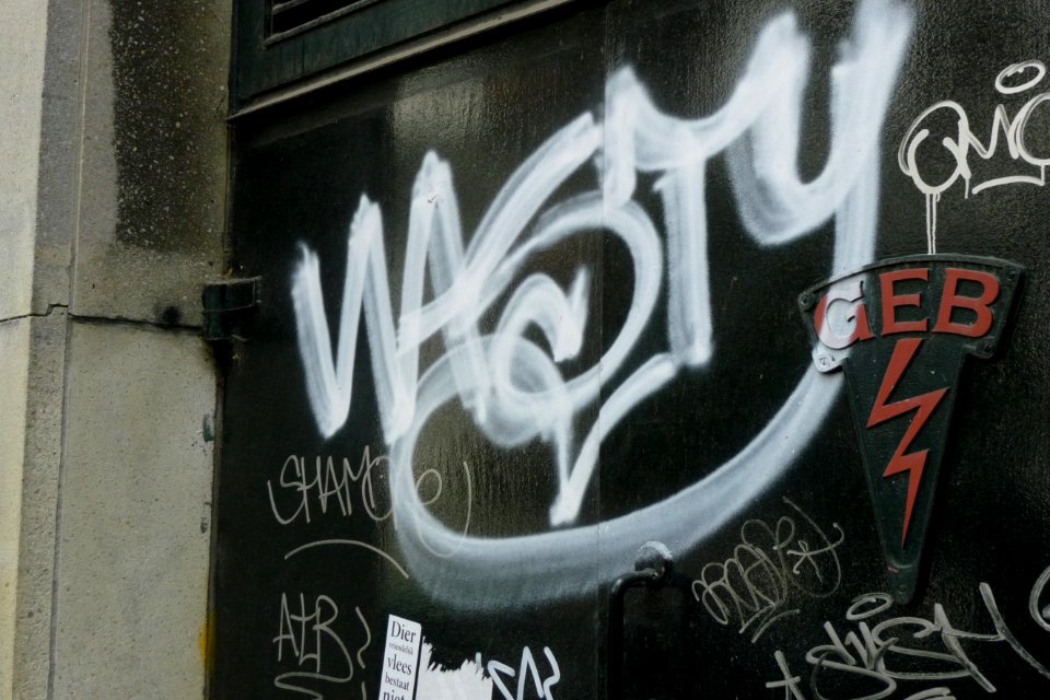 2011.05 - 'Street art on an dark-green wooden door', urban collage of tags; geotag free urban picture, in public domain / Commons CCO;  city photography by Fons Heijnsbroek, The Netherlands